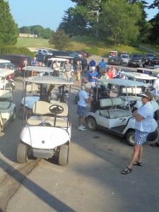 Golfers waiting for the shot gun start and getting last minute instructions