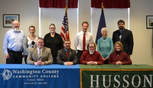 Participating in the Husson University/Washington County Community College credit transfer signing ceremony were (from left to right – standing) George Chmielecki, Computer Technology Instructor, WCCC; Elizabeth Sullivan, Human Services Instructor, WCCC; Rhonda French, Business Studies Instructor, WCCC; David Prescott, Ph.D., director of healthcare studies, School of Science and Humanities, Husson University; Deborah Drew, Ed. D., director of graduate counseling programs, College of Health and Education, Husson University; Chris Howard, Ph.D., assistant professor, School of Science and Humanities, Husson University; (from left to right – sitting) Alex Clifford, Dean of Academic Affairs, WCCC;  Joseph Cassidy, President, WCCC; Patricia Bixel, Ph.D., dean of the School of Science and Humanities, Husson University; and Marie Hansen, J.D., Ph.D., dean of the College of Business, Husson University.