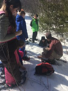 Adventure camp students learning how to identify and follow different animal tracks