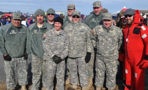 Miliary personnel at the annual polar bear dip pose for a picture.