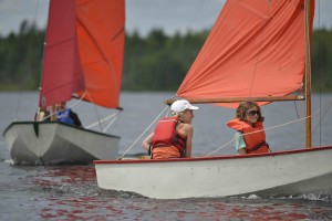 “Riley Fraser and Abby Leavitt enjoying learning how to sail at Keene’s Lake during last summer’s youth sailing program. Photo by Sam Winch.”
